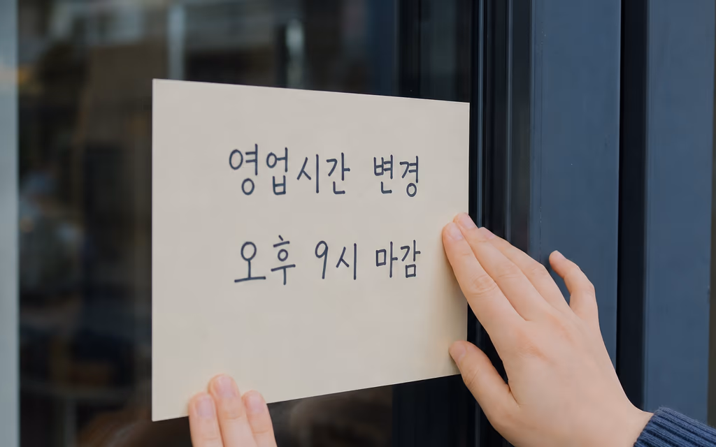 영업시간 변경을 알리는 메모를 붙이는 손